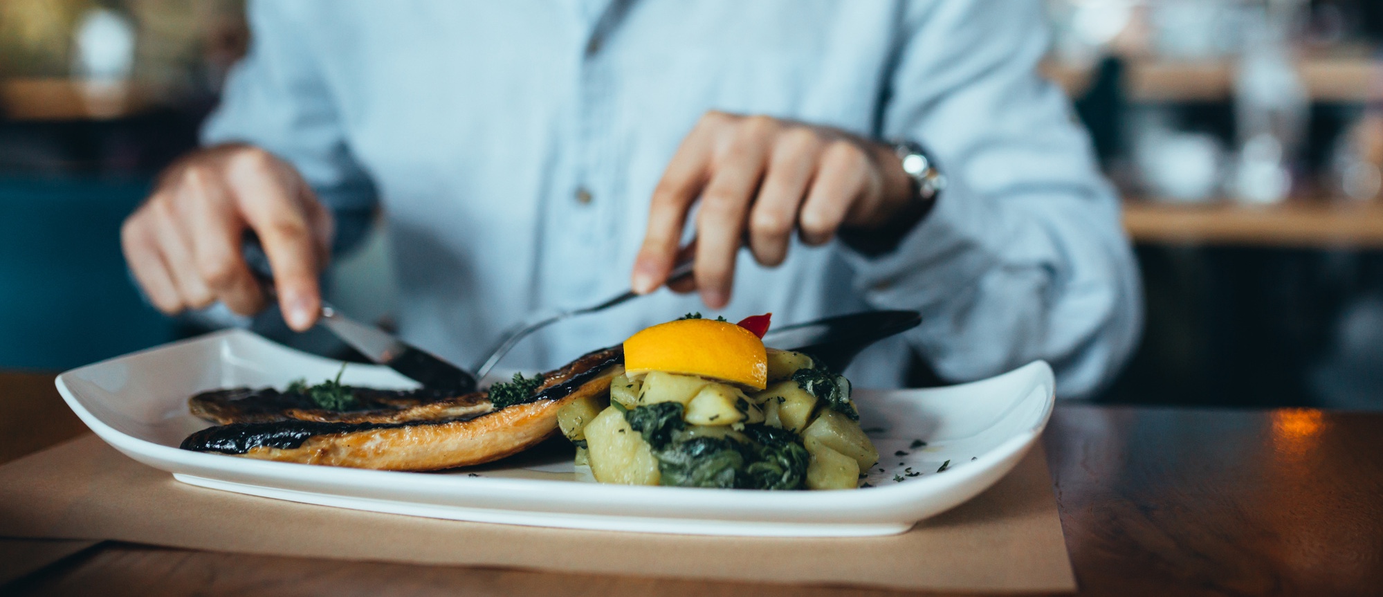 Close up of man eating lunch in restaurant