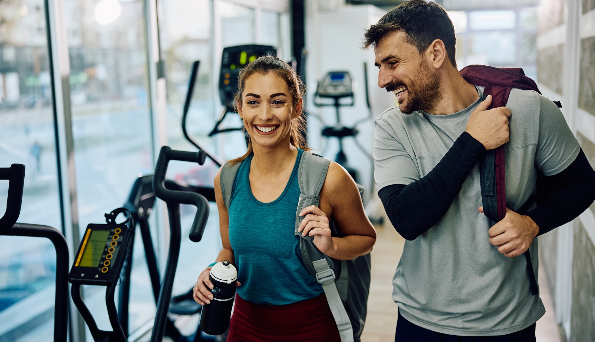 Photo of a happy athletic couple at the gym after fat reduction treatments