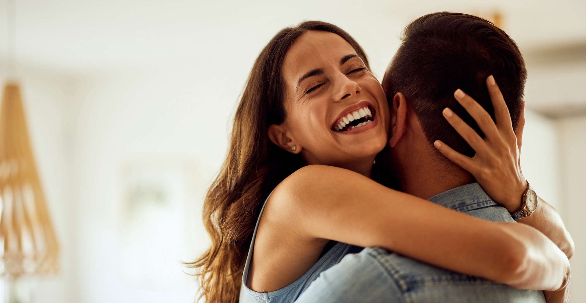 An adult happy couple hugging at home, looking in love and satisfied after ThermiVa® treatments