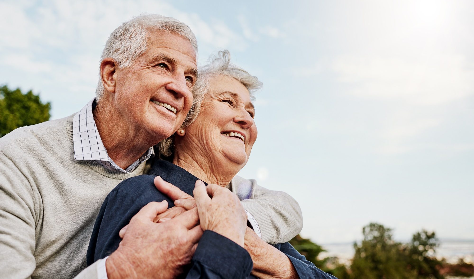 Photo of an older husband and wife embracing after thyroid hormone therapy