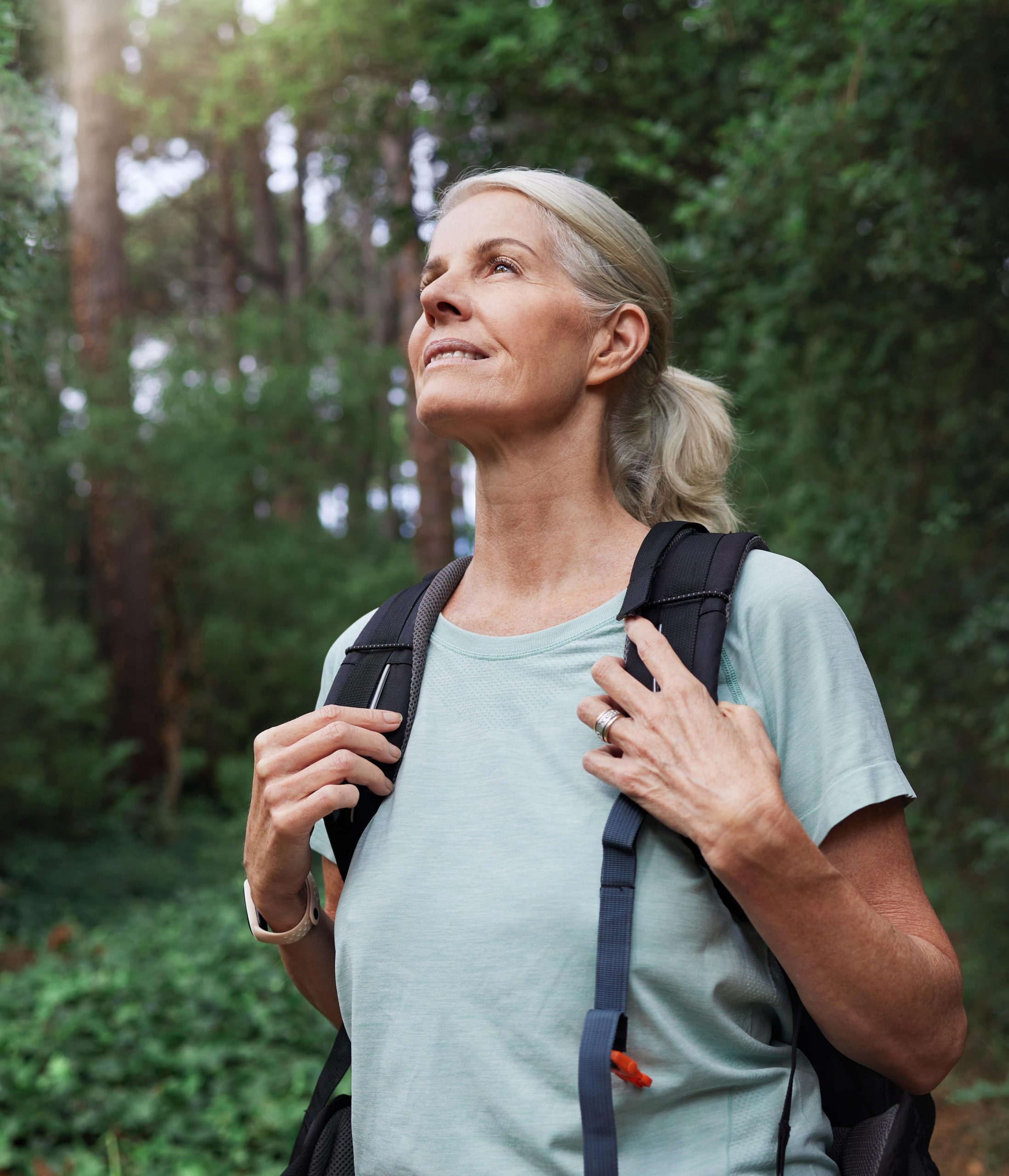 Photo of a middle-aged woman hiking in the woods