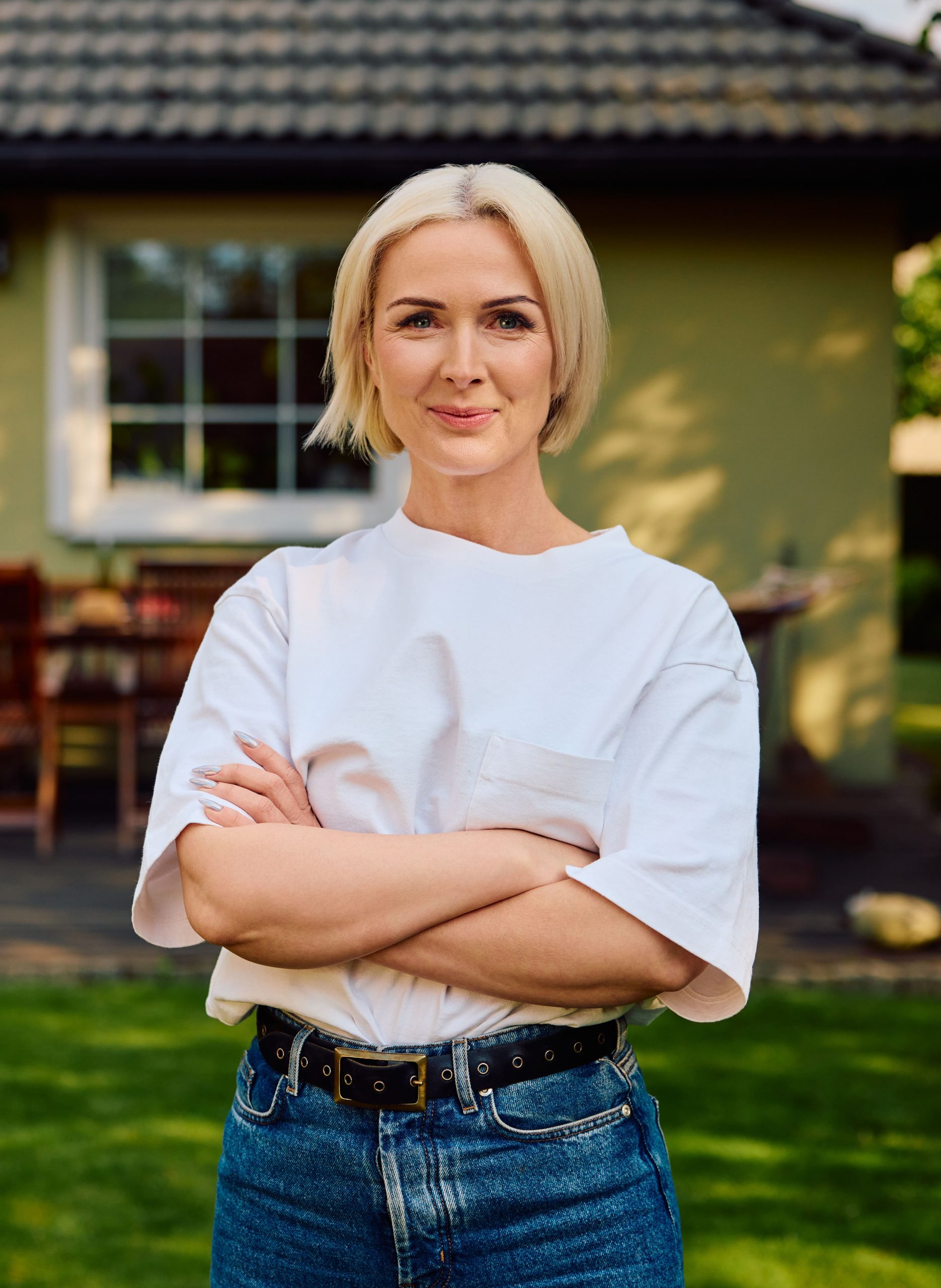 Photo of an older woman with shorter, blonde hair and smooth skin