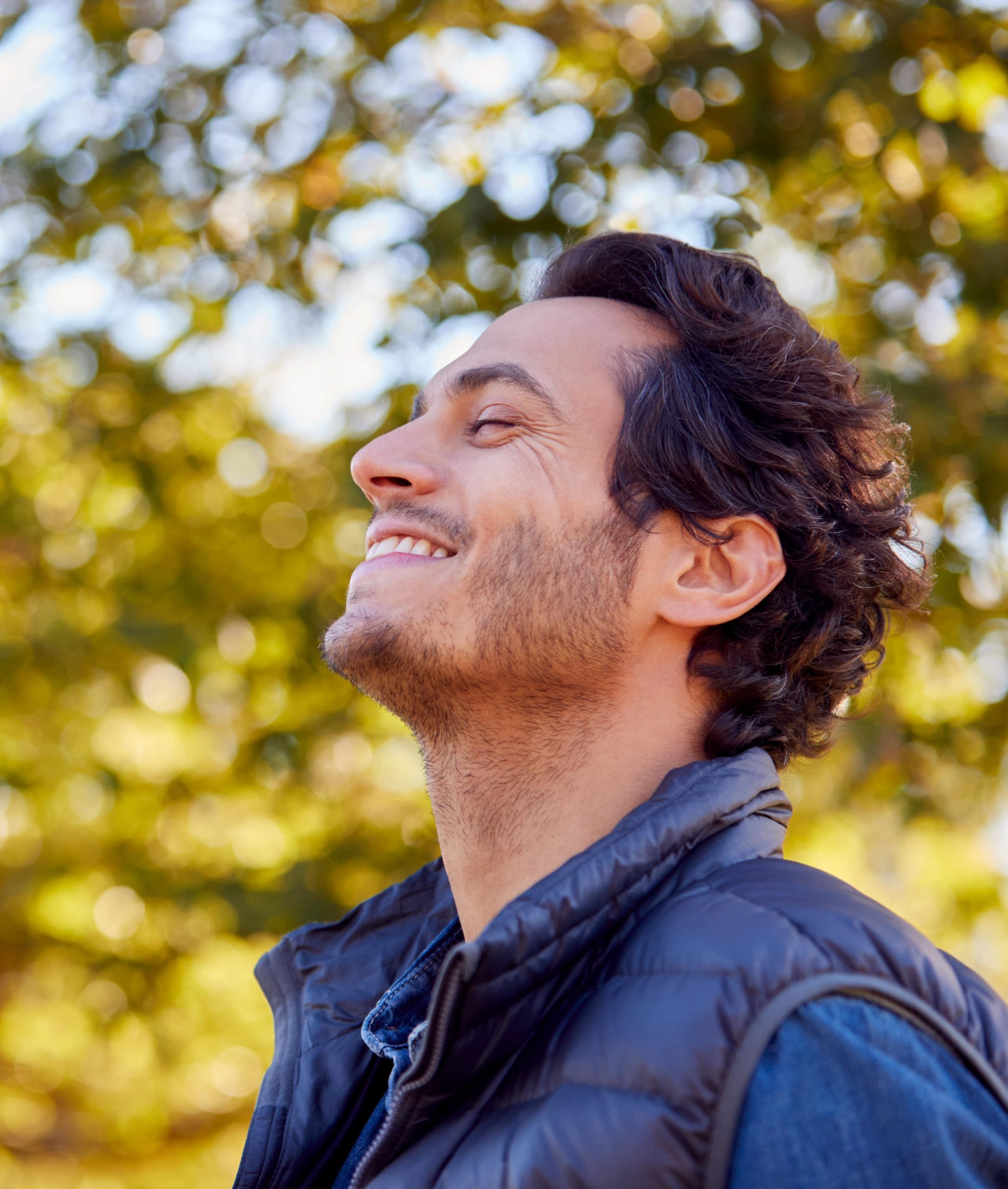 Photo of a smiling man with a full head of hair after PRF hair restoration