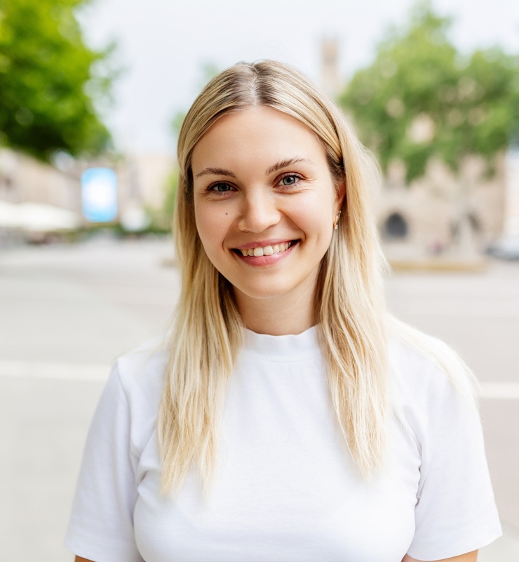 Smiling portrait of young caucasian woman with wrinkle-free skin after DAXXIFY® treatments