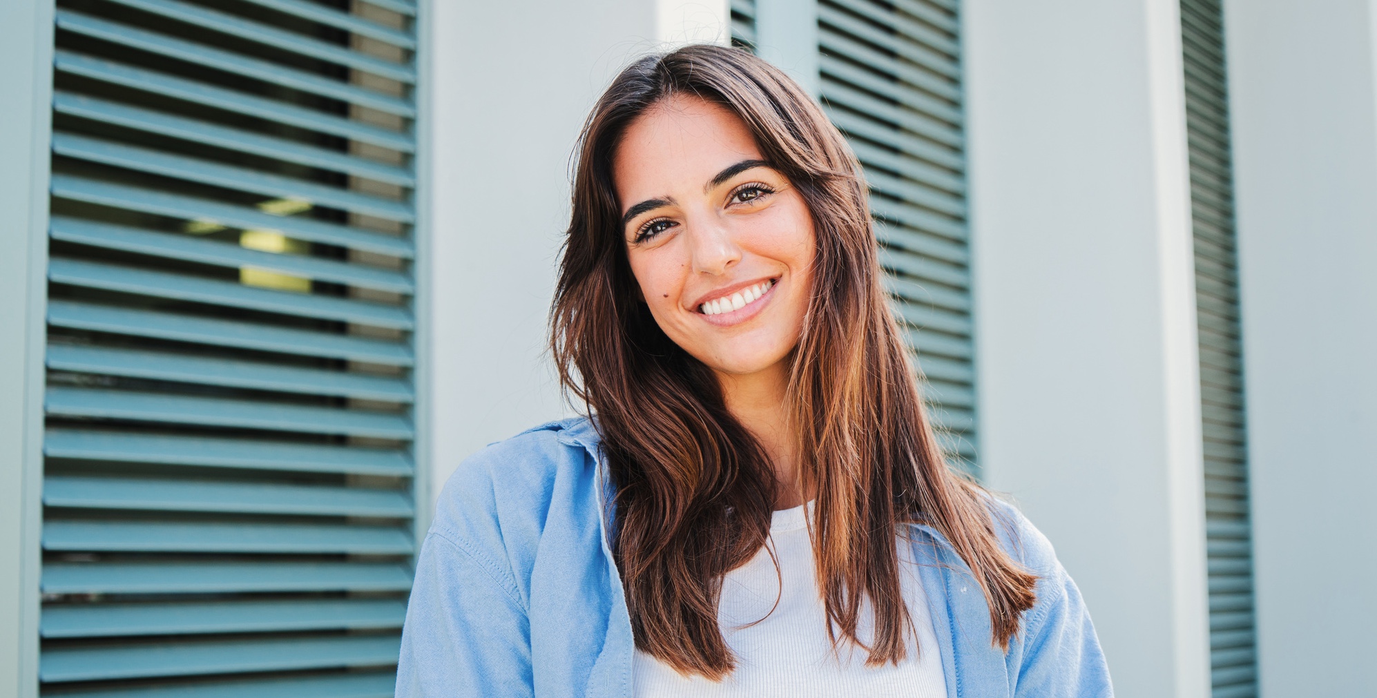 Smiling young woman with clear skin after acne treatment