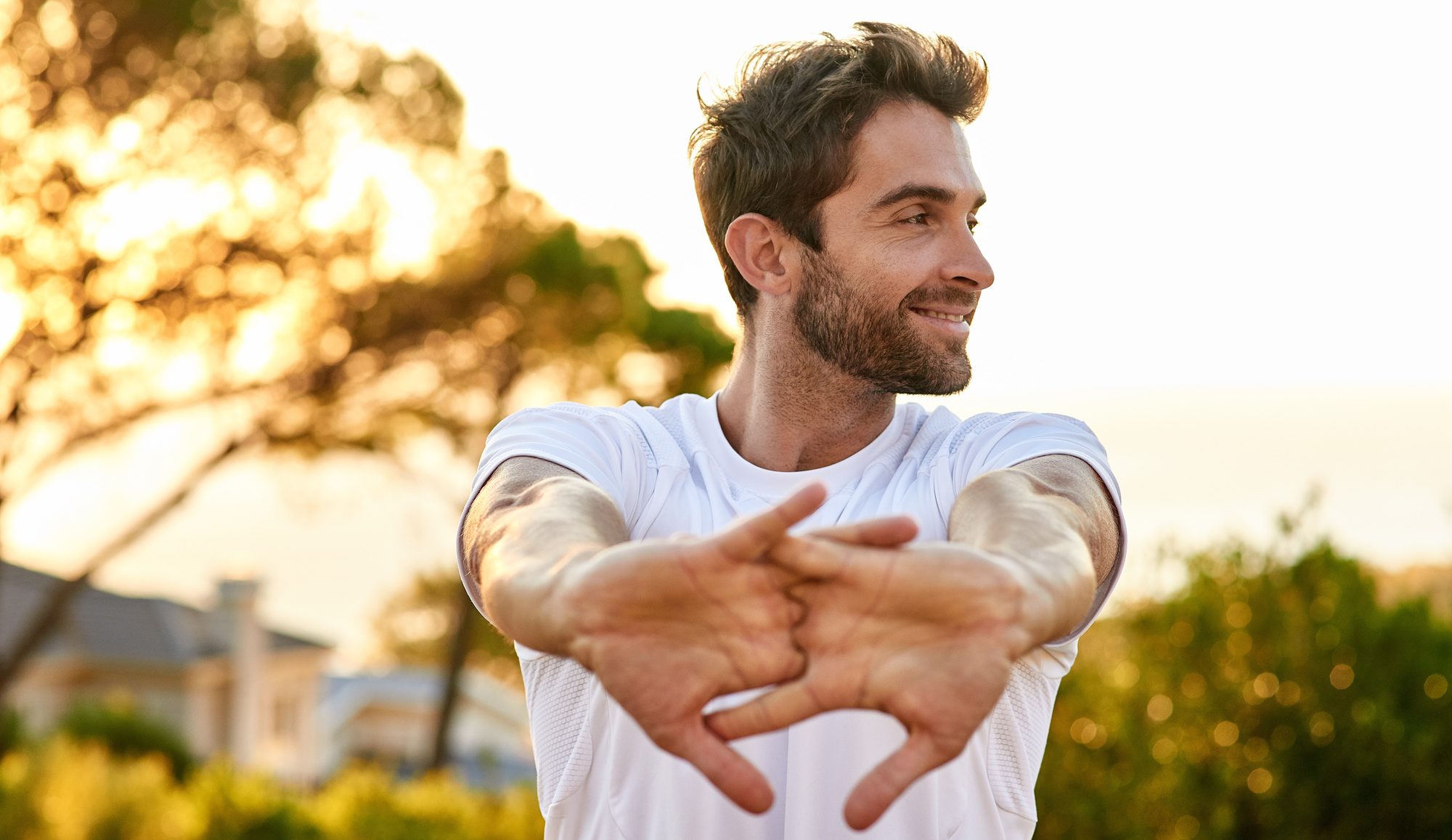 Shot of a man stretching before a run and after Human Growth Hormone Therapy