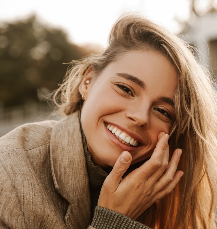 Close-up of cute young fair-skinned lady smiling after Dysport® treatments