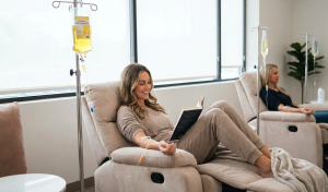 Patient relaxing in a recliner chair receiving IV vitamin therapy at a clinic